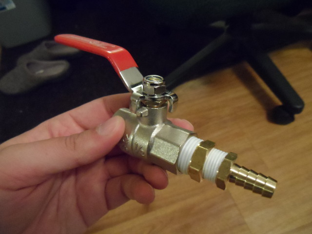 a barb fitting inserted into a ball valve