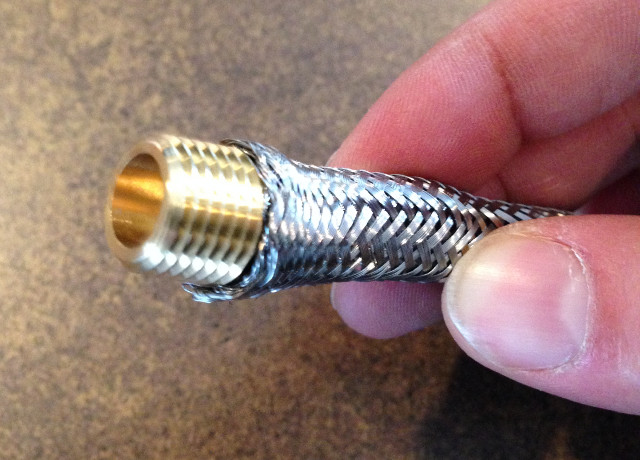 Square head plug inserted into stainless braid